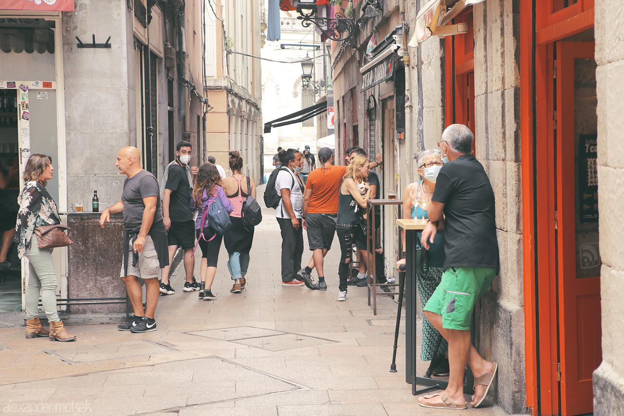 Foto von A candid glimpse of lively Bilbao's streets as locals engage near a bar in Casco Viejo.