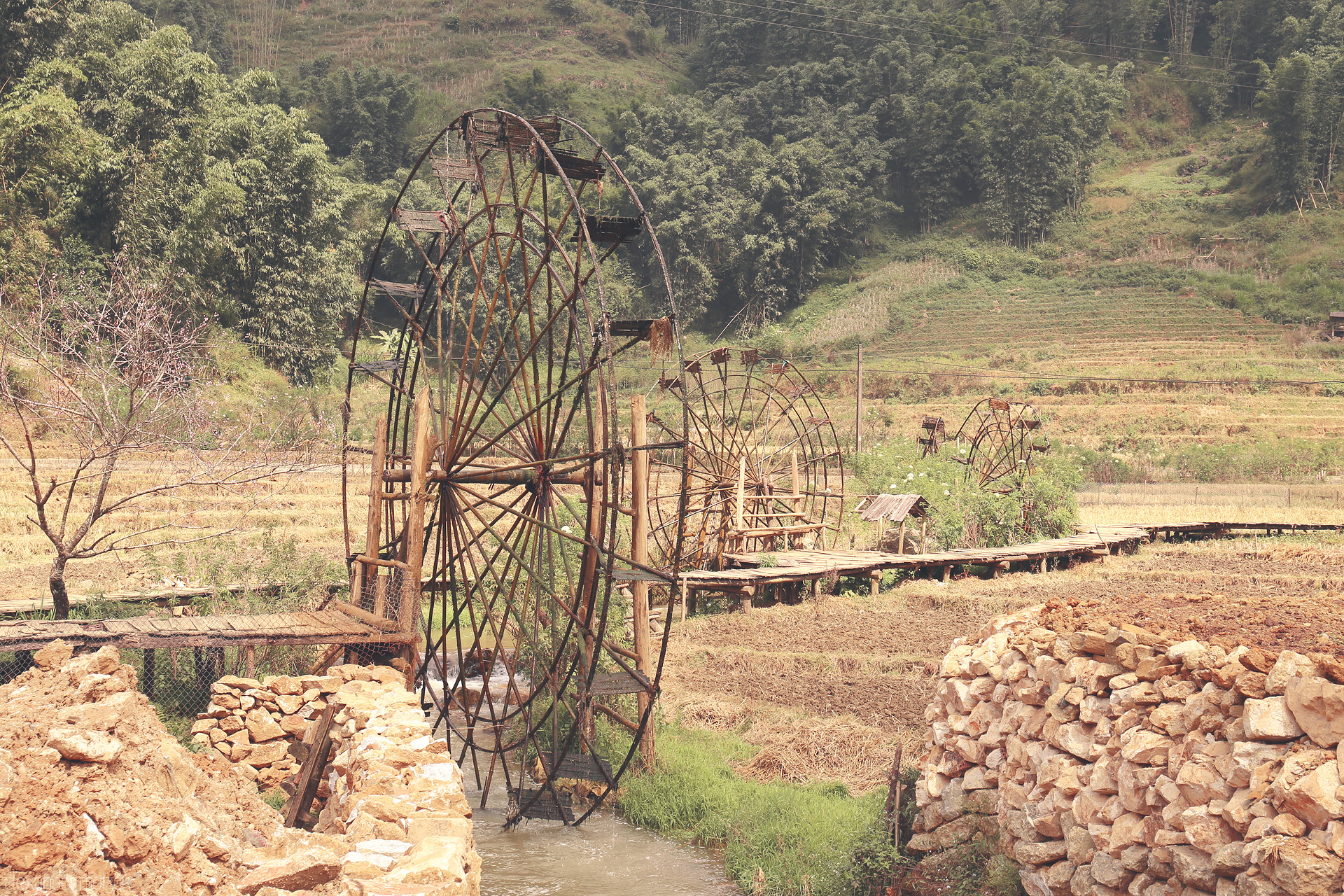 Foto von Bamboo water wheels turn gently in Sapa’s terraced fields, blending tradition with the serene beauty of northern Vietnam’s landscape.