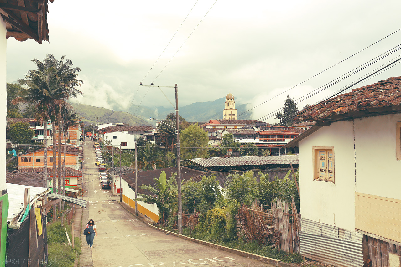 Foto von Discover the charm of Salento, Quindío, Colombia, with its peaceful streets, lush greenery, and picturesque church steeple against misty Andean hills.