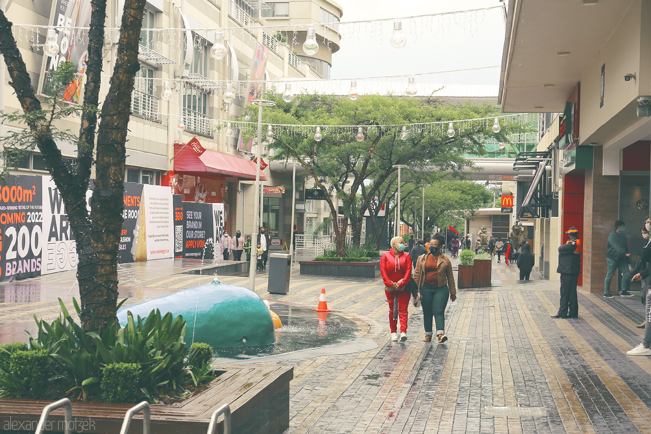 Foto von Amidst Sandton's lively streets, pedestrians wander past art, greenery, and iconic buildings, embodying Johannesburg's dynamic energy.