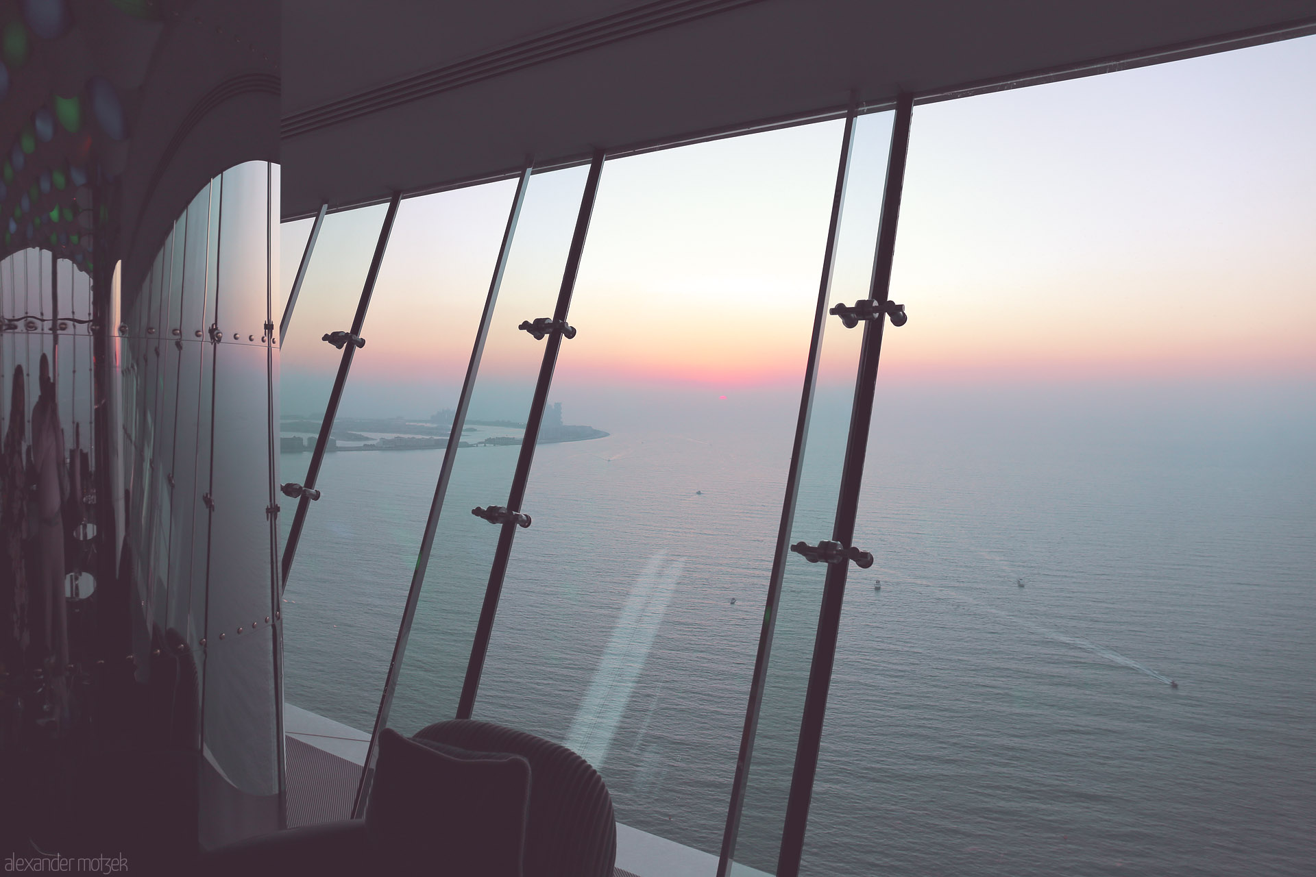 Foto von Through Burj Al Arab’s glass, Dubai’s coast glows at sunset—modern luxury meeting the tranquil Persian Gulf.