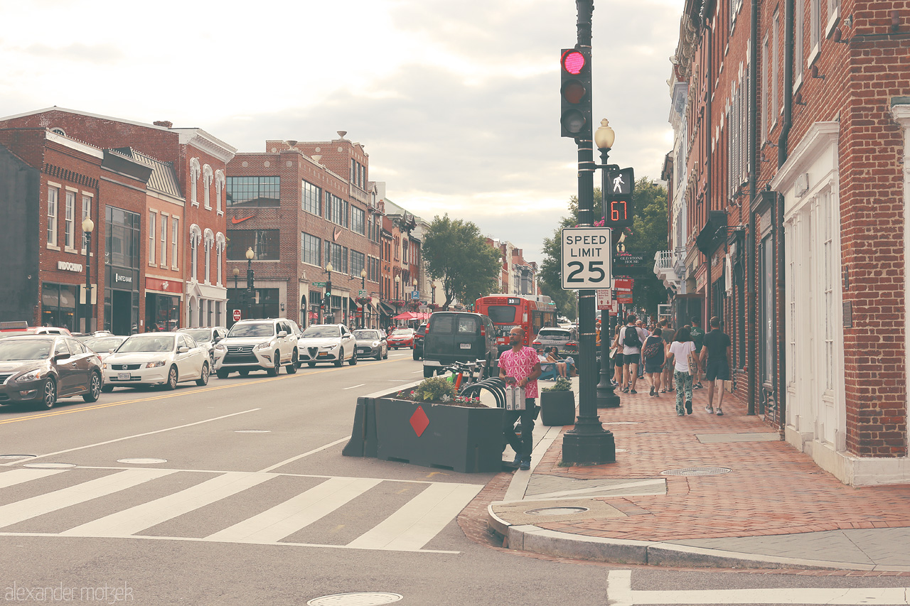 Foto von Bask in the urban charm of Georgetown, D.C., where historic bricks meet bustling street life under soft skies.